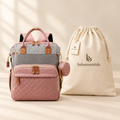 Pink-and-grey nappy backpack with babaessentials packaging